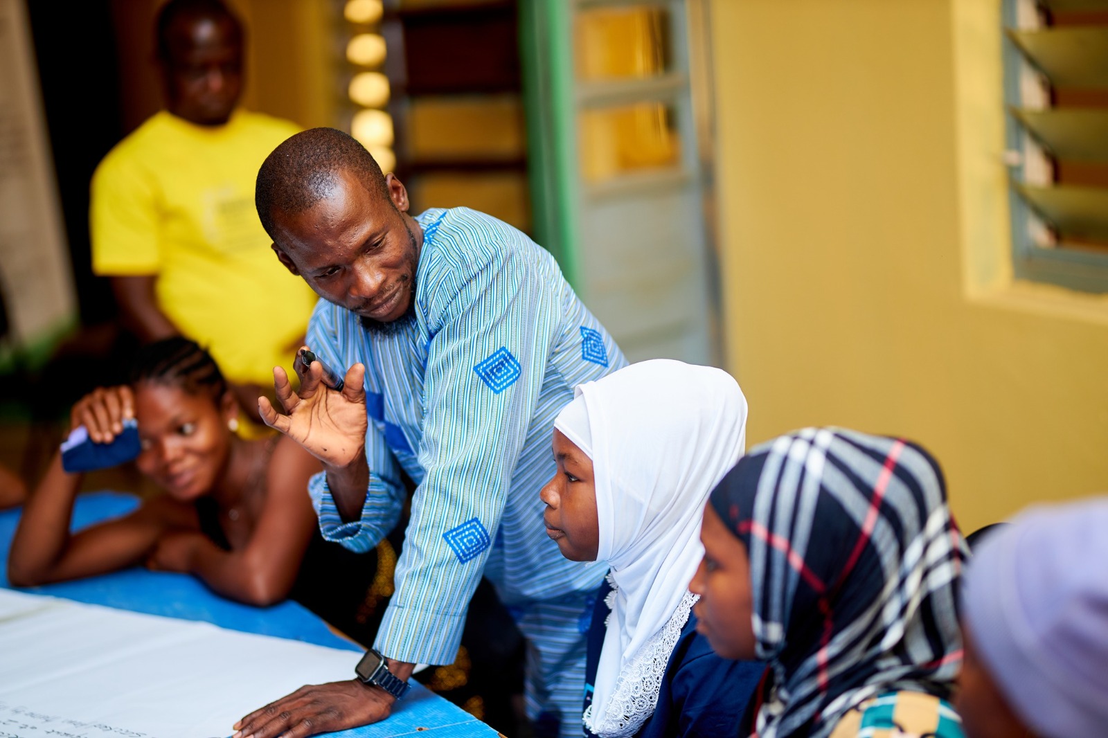 A facilitator working with a diverse group of participants